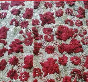 Dense red floral hand embroidery